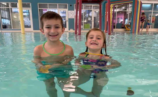 Two children smiling in the Morrison YMCA pool