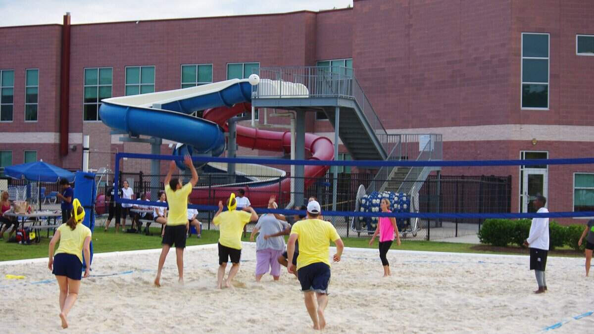 Community members playing volleyball near the former Morrison YMCA waterslides